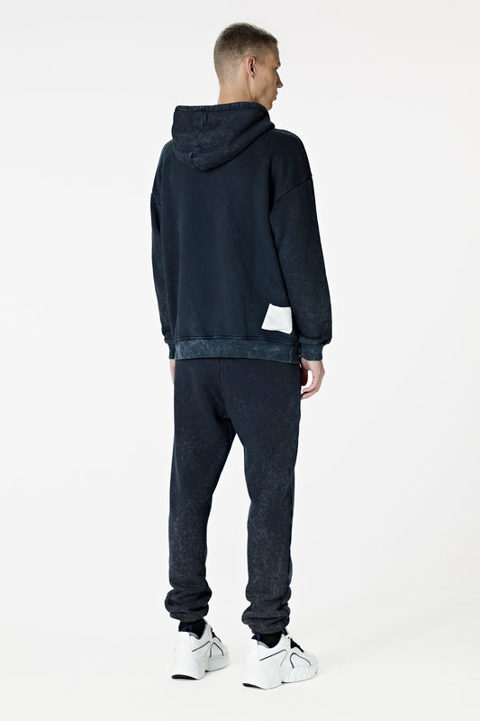Male Model wearing black washed hoodie - BODA SKINS. back facing