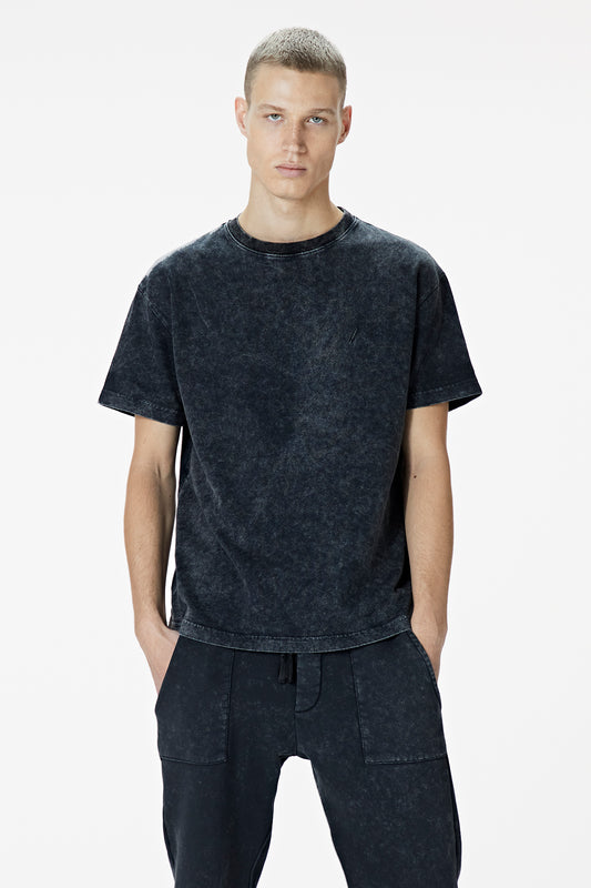 Male Model wearing the washed black tee-shirt- BODA SKINS. Front Facing.
