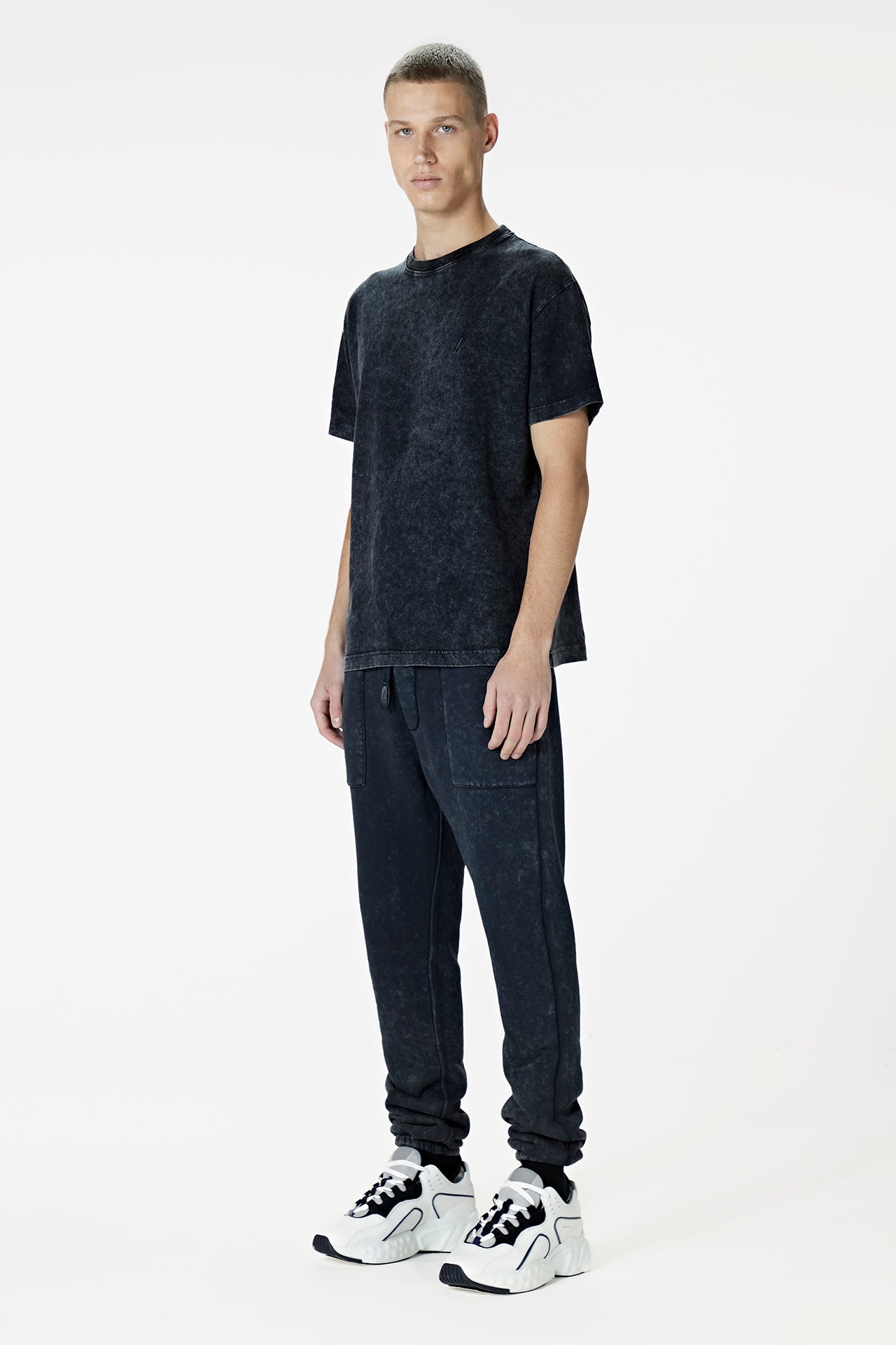 Male Model wearing the washed black tee-shirt- BODA SKINS. Front Facing.